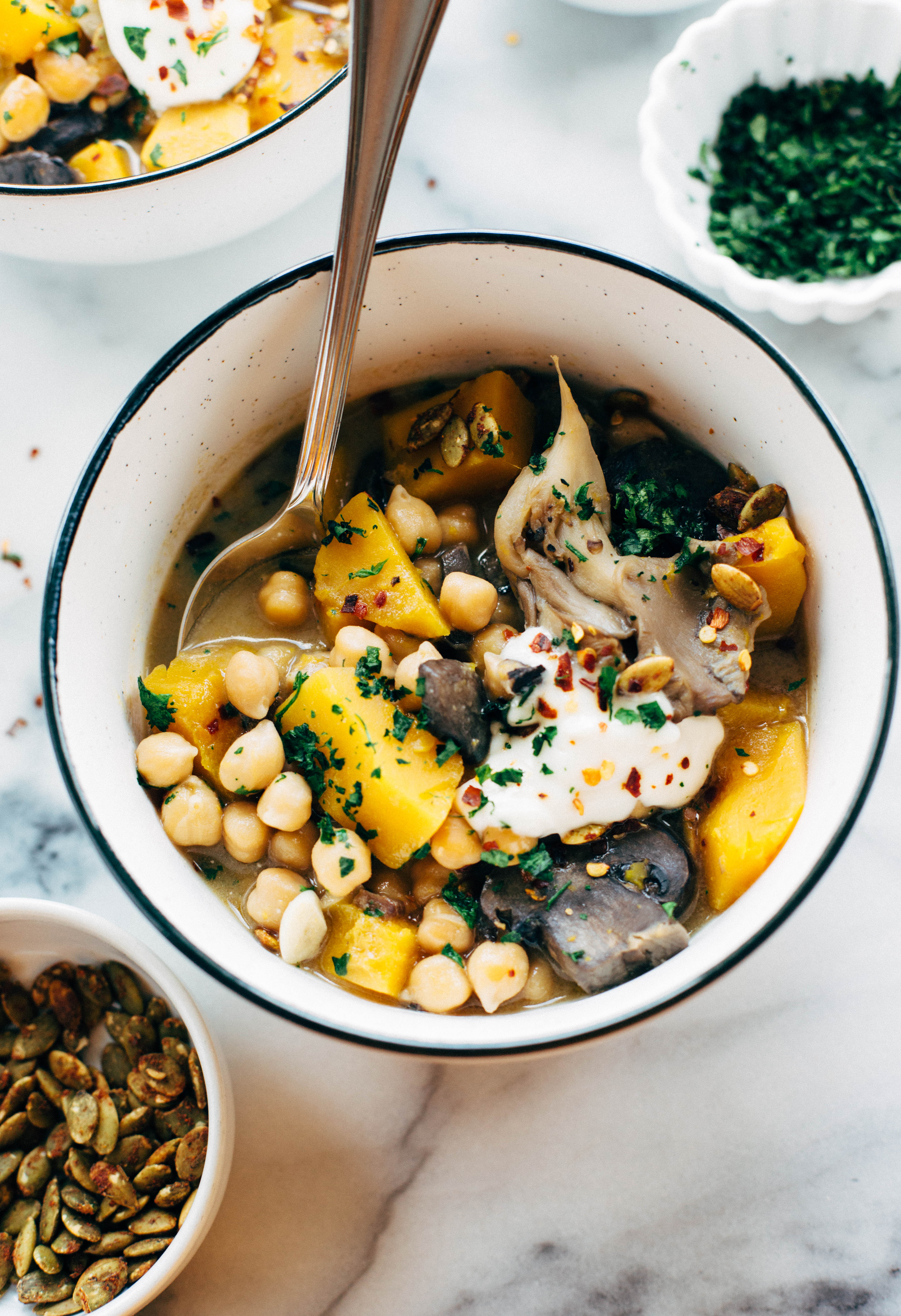 pumpkin stew in bowl with garnish along side