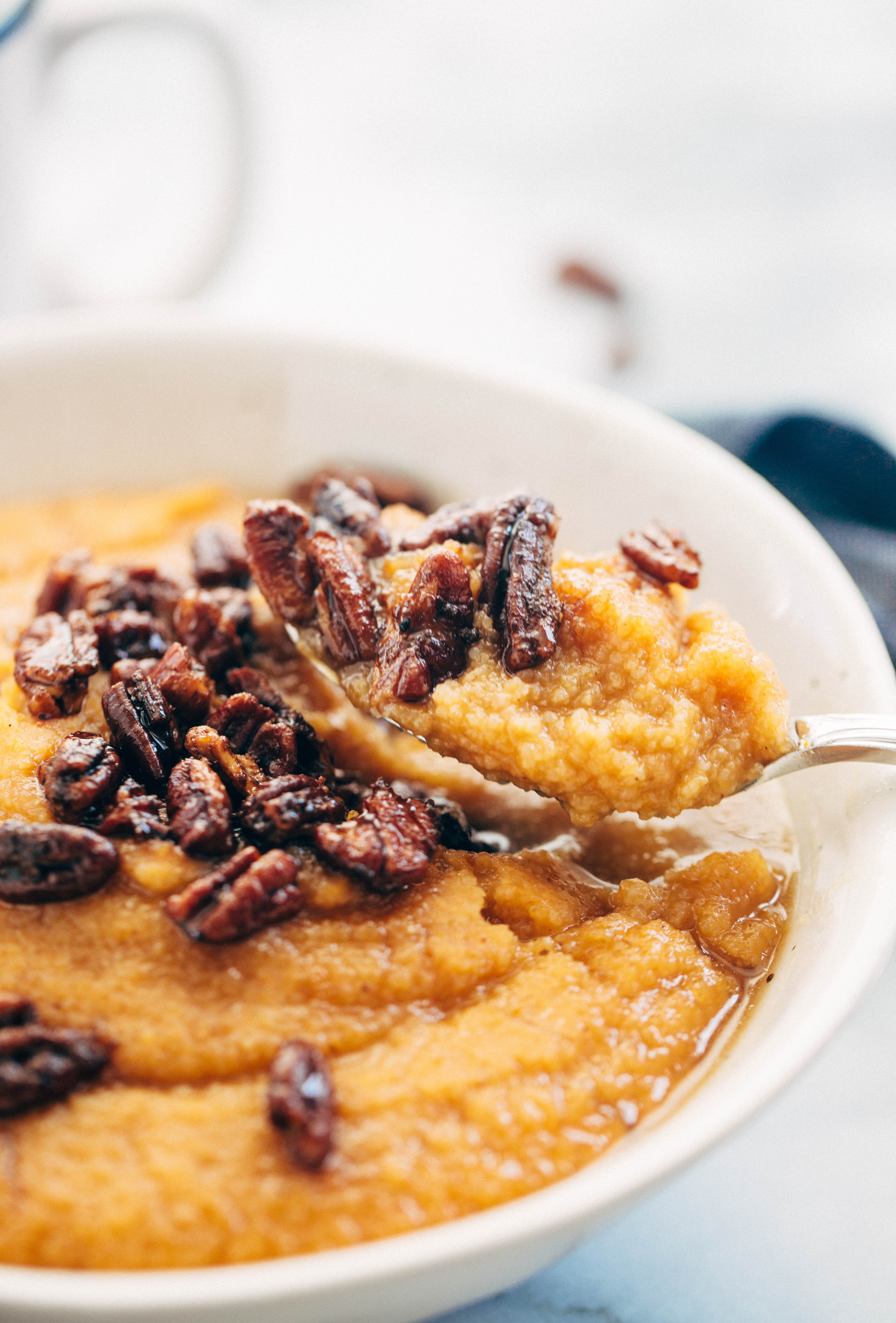 fonio in spoon topped with pecans