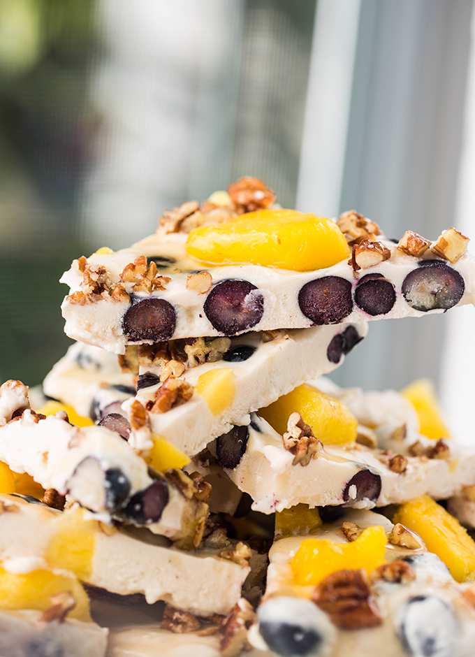 frozen blueberry pineapple yogurt bark on a plate