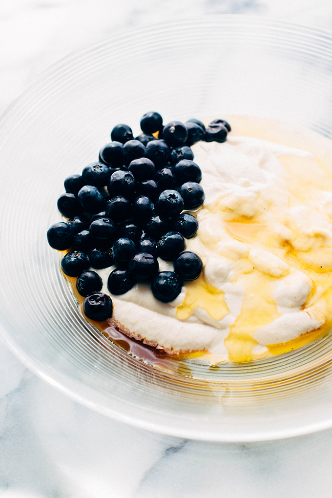 Blueberries in bowl with yogurt, vanilla, and honey