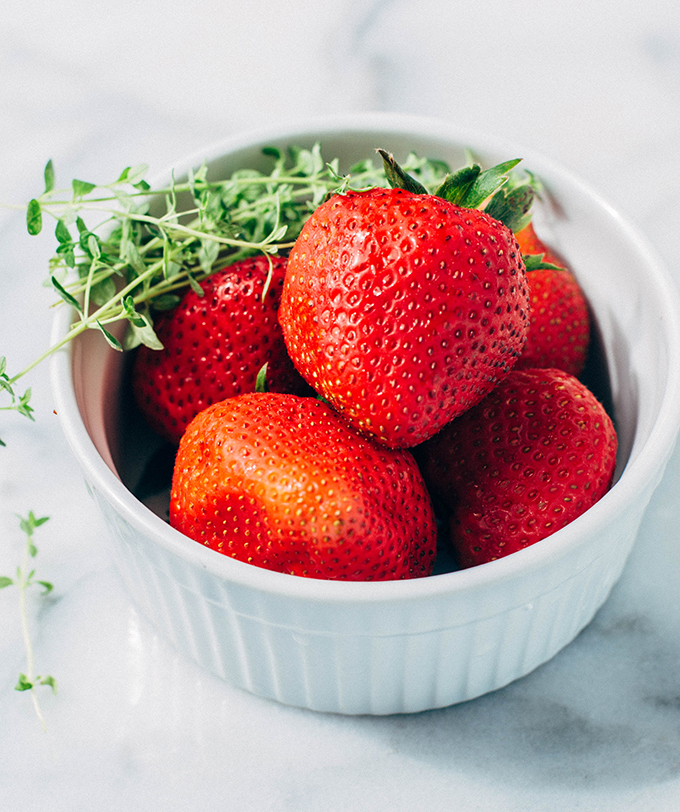 strawberries and thyme in a bowl