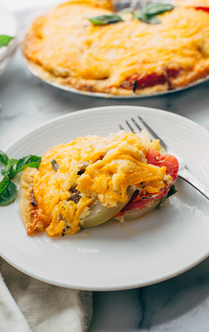 fresh tomato pie served on saucer plate with a fork